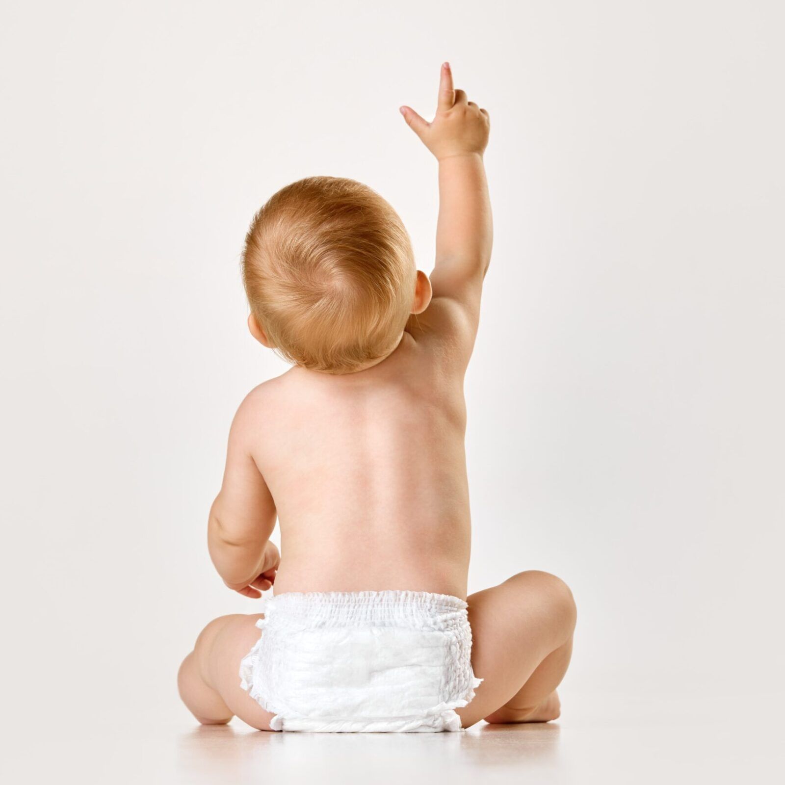 toddler sitting in diaper