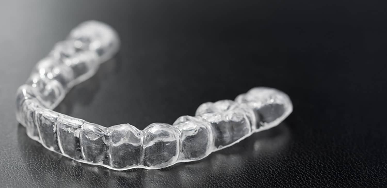 Transparent plastic dental retainer