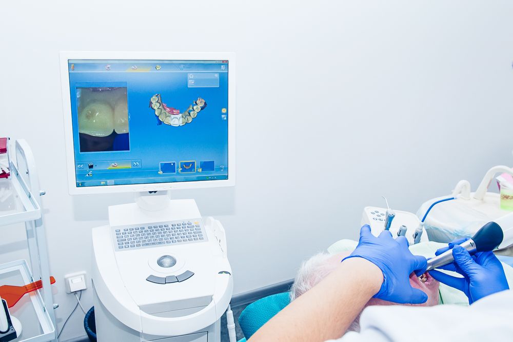 Doctor modeling prosthesis using CAD CAM dental computer-aided machine in a highly modern dental laboratory