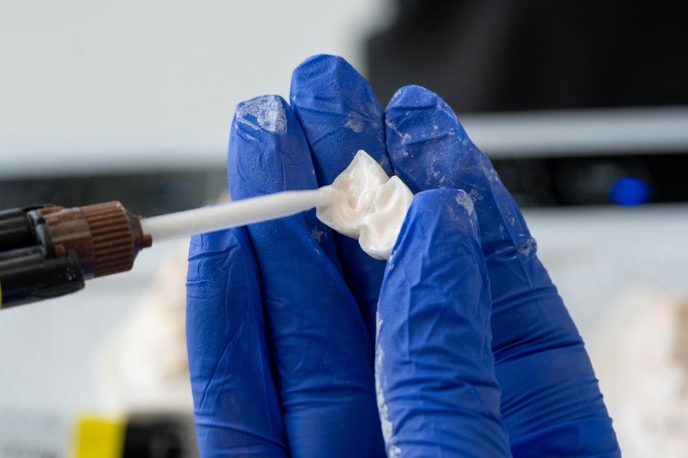 applying glue before putting dental crowns