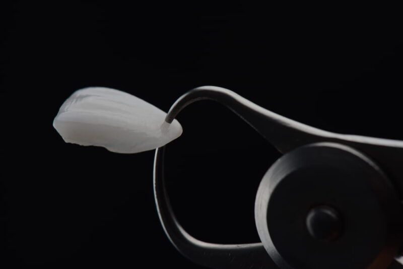 Dental veneer thickness measurement with black background.