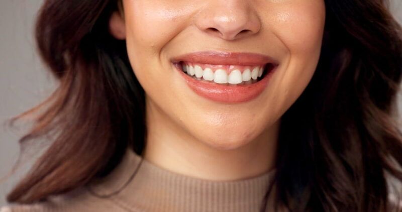 Mouth, closeup and woman in studio. smile and beauty with dental hygiene on gray background