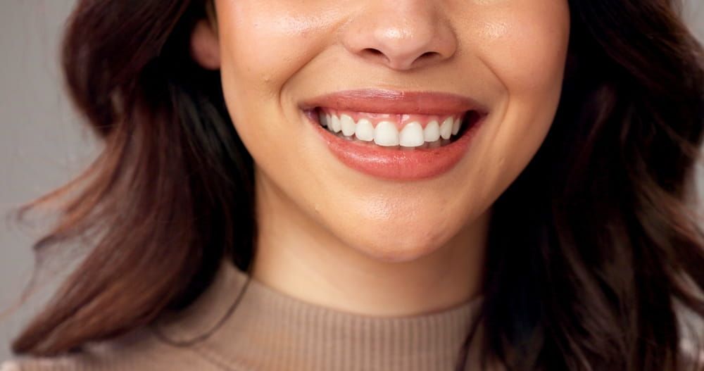 Mouth, closeup and woman in studio. smile and beauty with dental hygiene on gray background