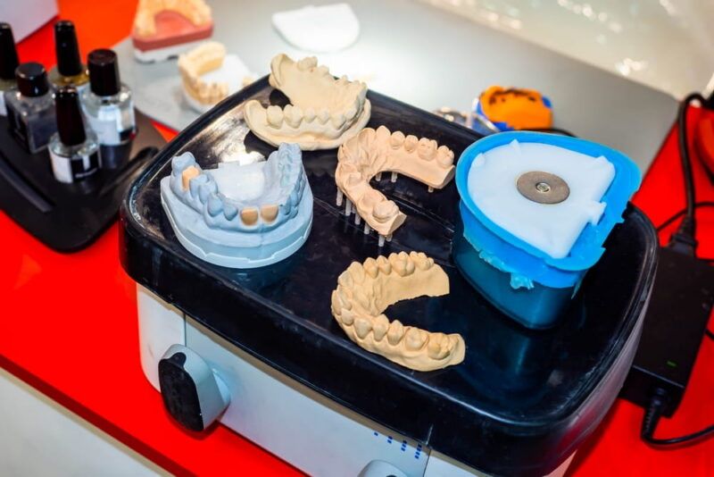 Dental technician workplace. Prosthetic dental plates. Artificial teeth. Making artificial teeth