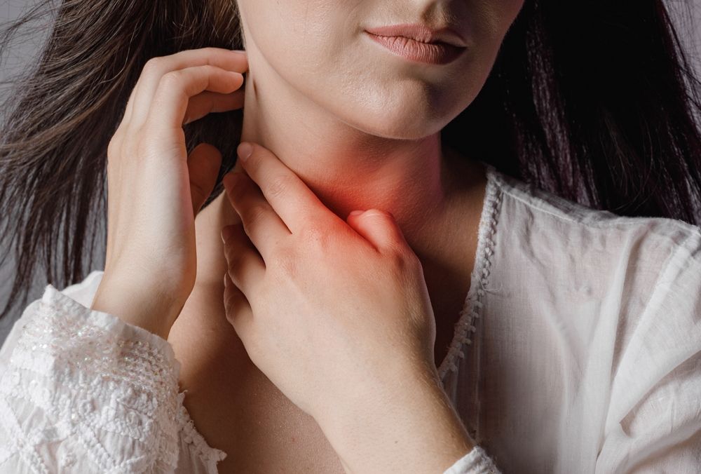 Woman Touches Neck Throat With Hand