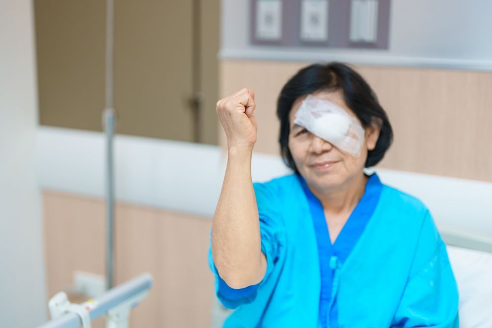 Elderly Woman with eye protective shield after eye surgery