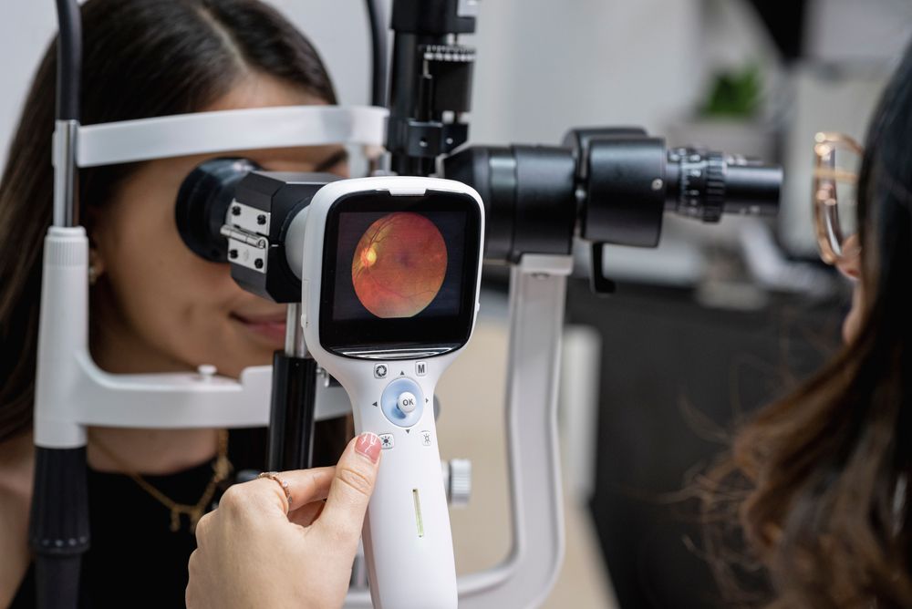 Eye doctor performing an eye fundus examination with retinal camera.