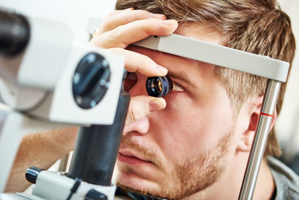Ophthalmology concept. Male patient under eye vision examination in eyesight ophthalmological correction clinic