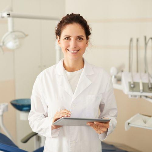 confident female dentist smiling