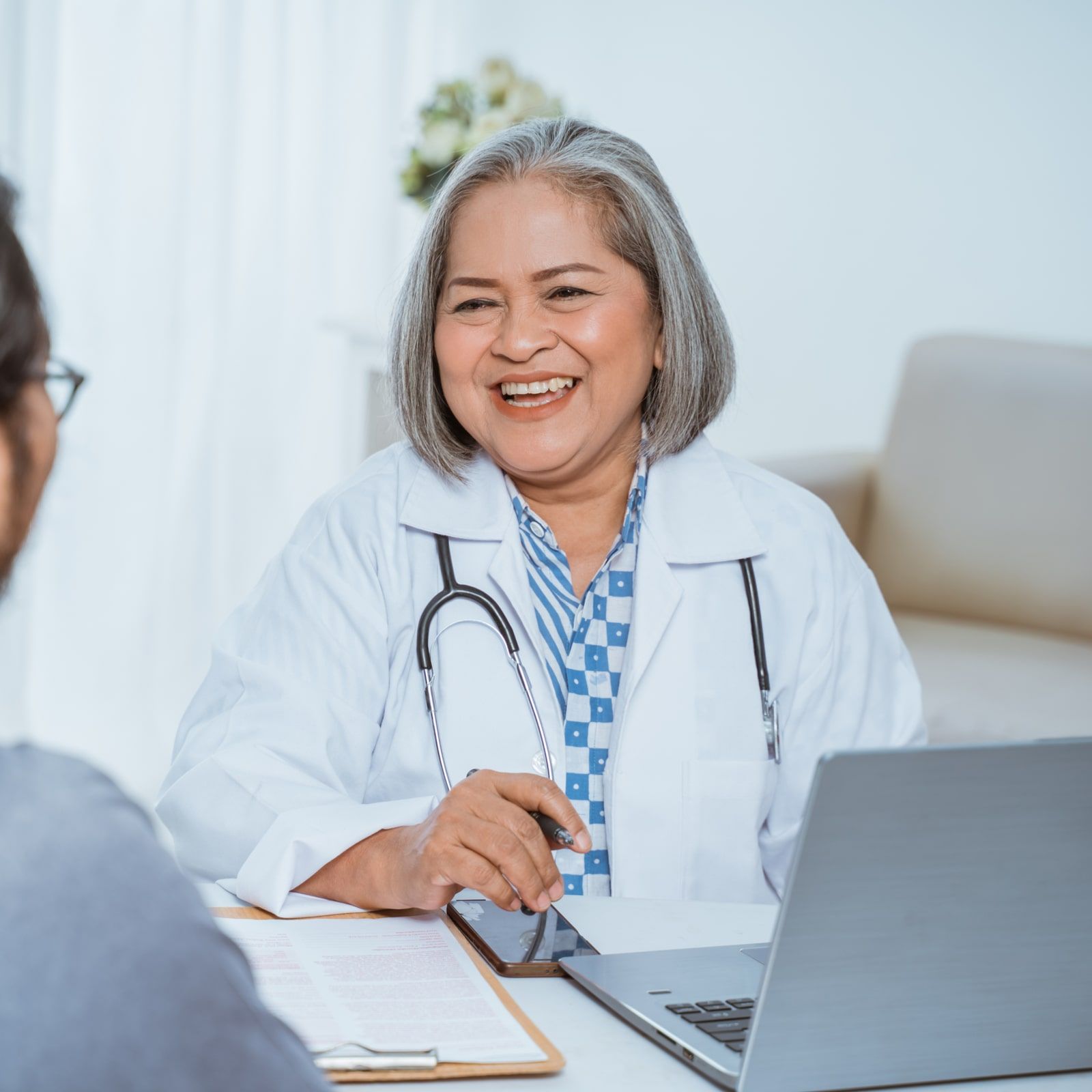 Doctor talks with the patient during the examination
