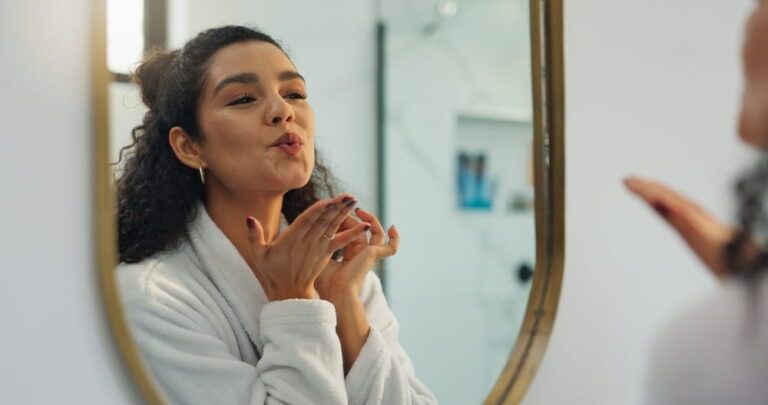 Kiss, mirror and beauty with woman in bathroom for morning routine