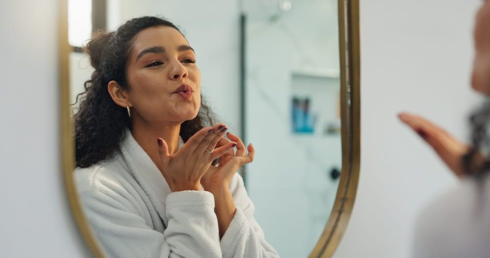 Kiss, mirror and beauty with woman in bathroom for morning routine