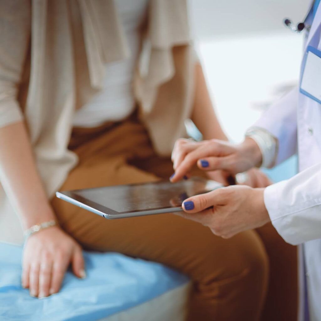 Doctor and patient discussing something while sitting