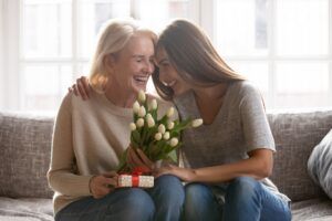 excited elderly mother with loving daughter