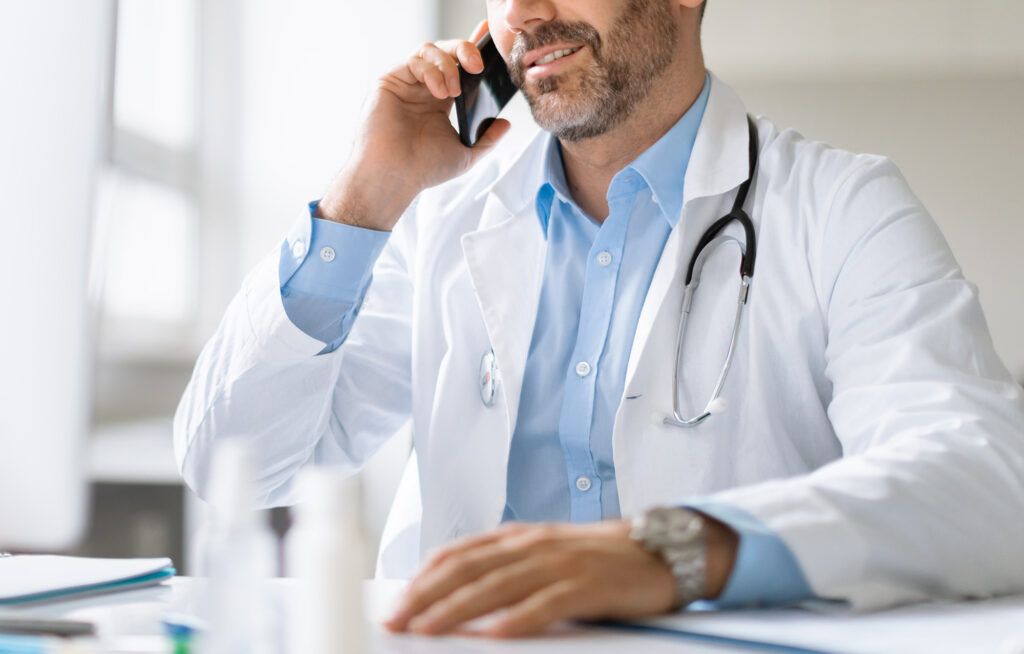 male doctor talking on cellphone