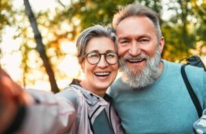 cheerful couple smiling and taking selfie