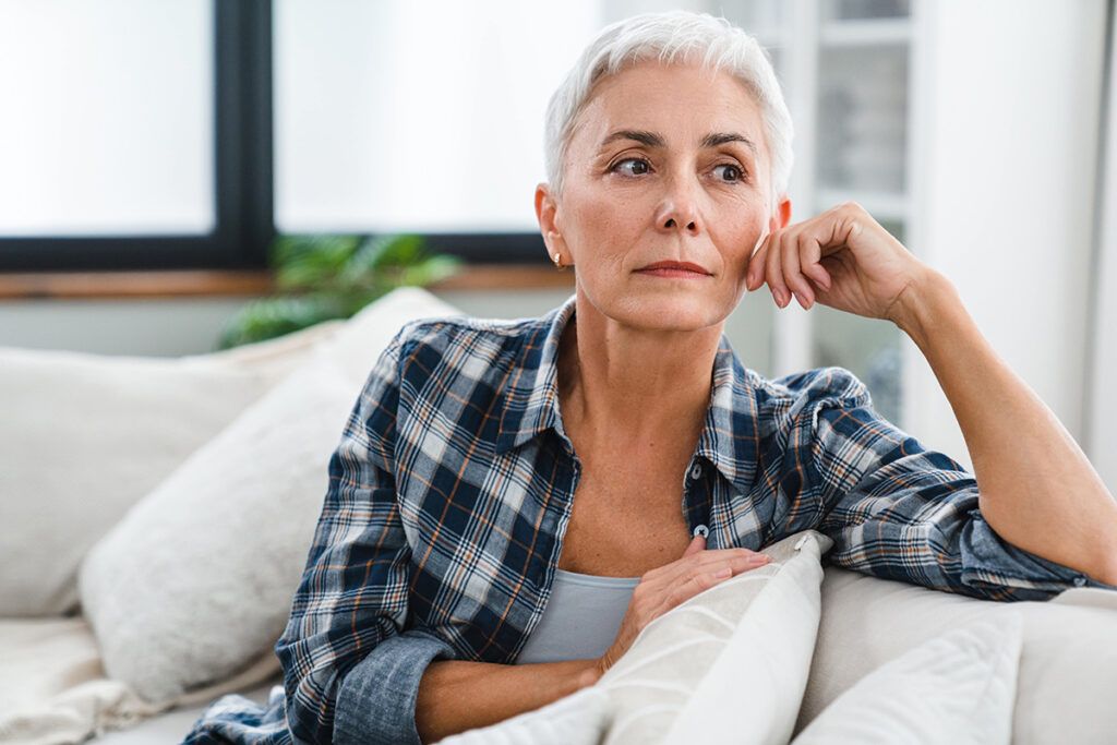 middle-aged woman suffering from health issues at home