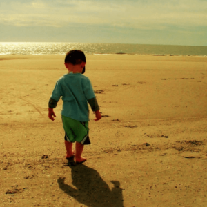 Kid standing on beach