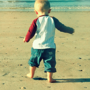 A kid enjoying on beach's sand