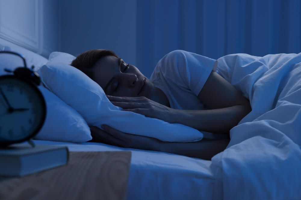 Woman sleeping in bed at night