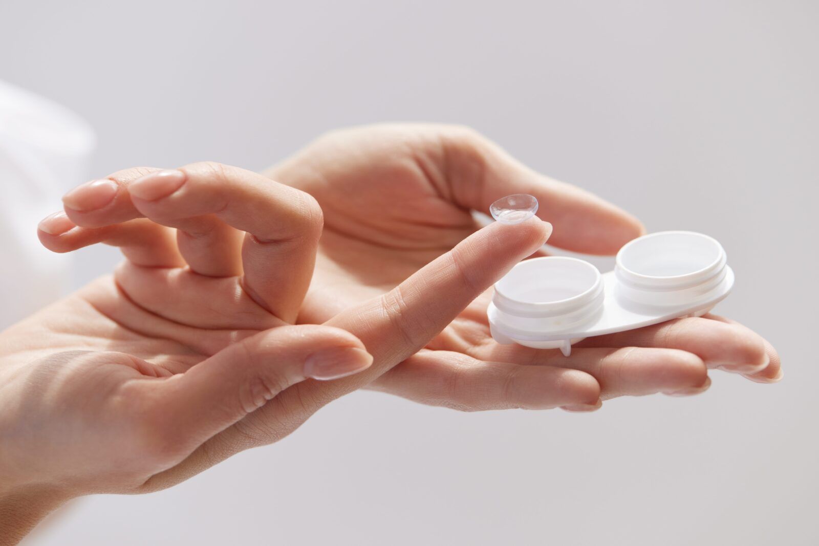 Woman Hands Holding Contact Eye Lens