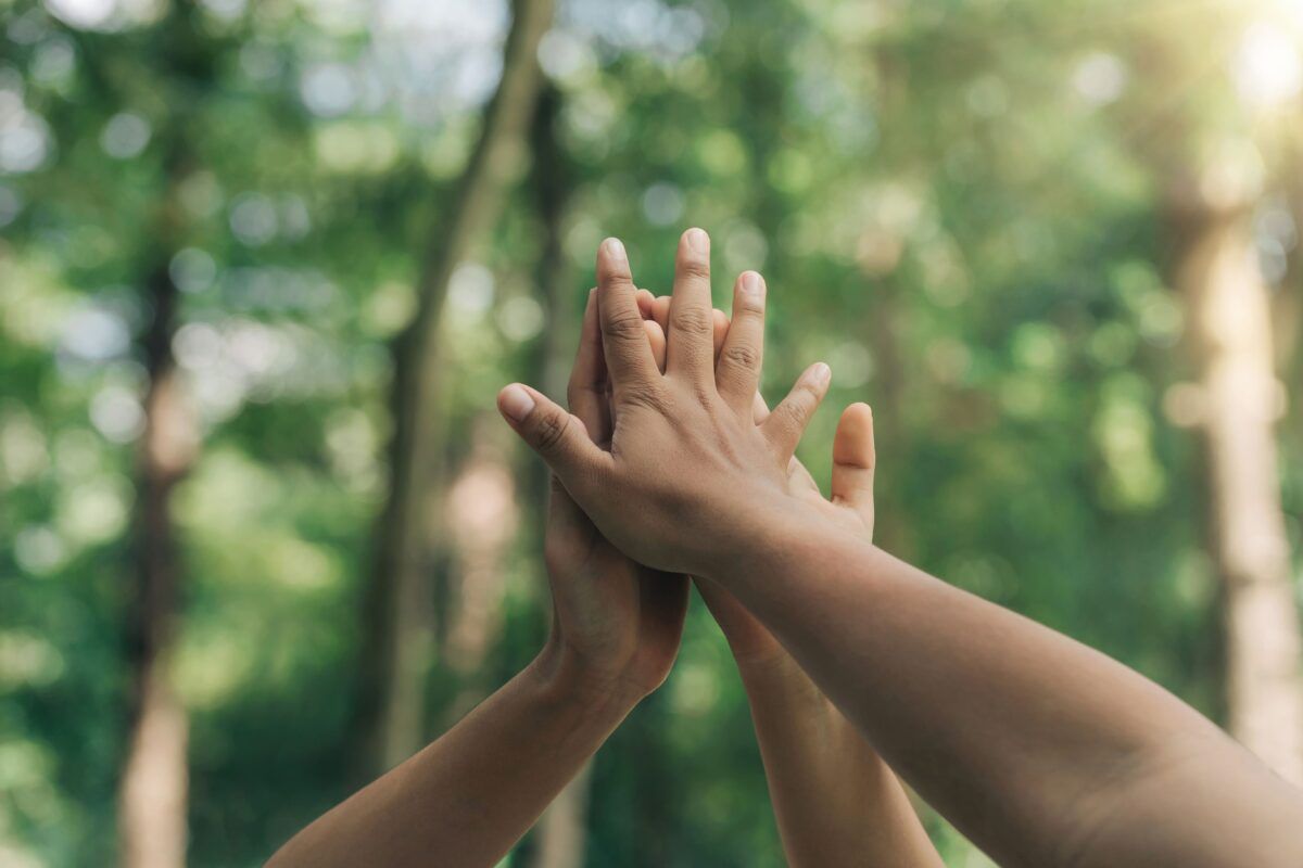 Volunteers joining hands together