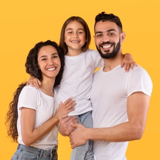 Parents And Daughter Embracing Together