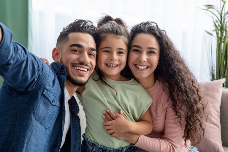 Cheerful Man Taking Photo With Wife And Little Daughter