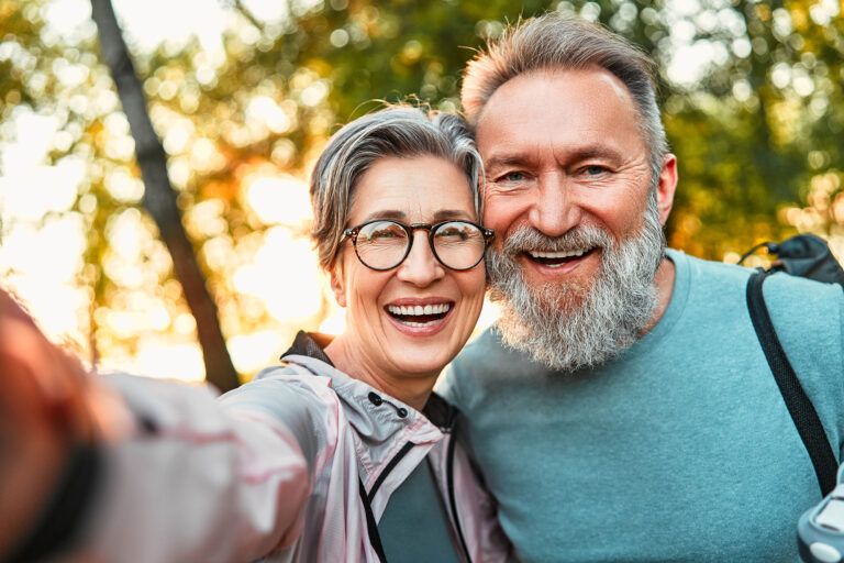 cheerful couple mature smiling & taking selfie