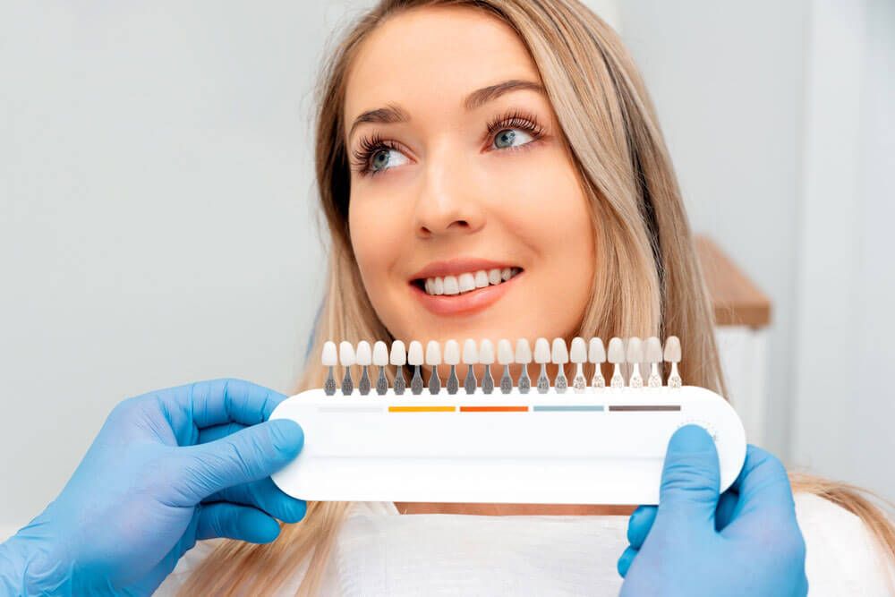 Choosing a shade of dental veneers.