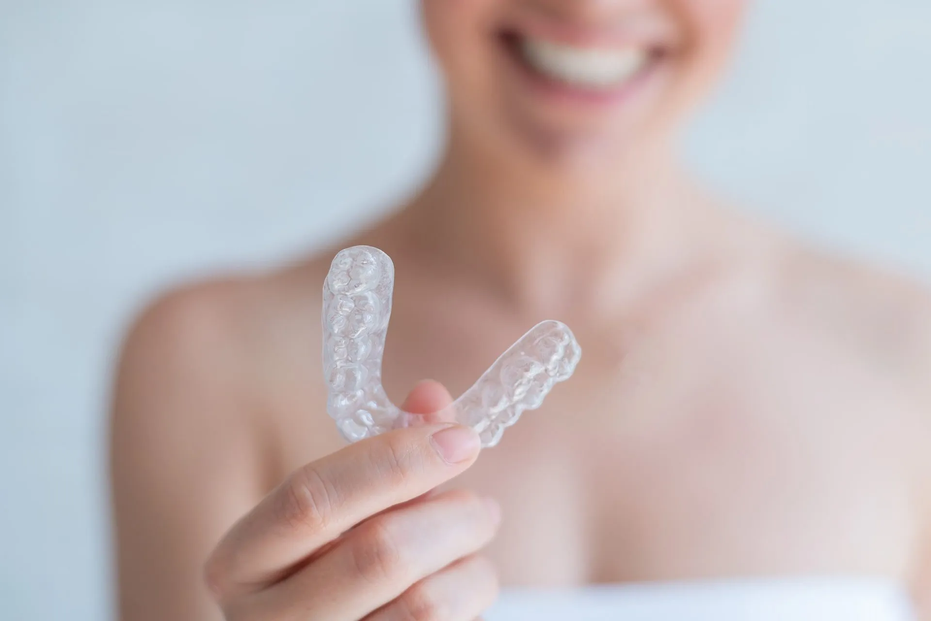 orthodontic silicone transparent teeth aligner in female hands