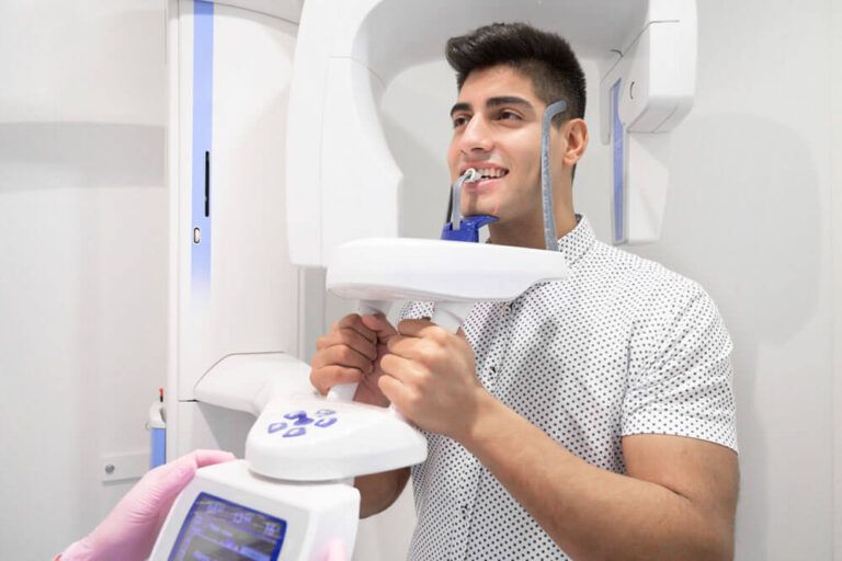 Young man patient standing in x-ray machine