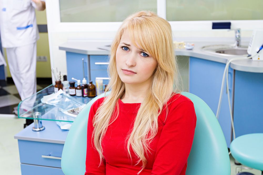 Closeup portrait sad, young girl, woman with painful tooth, ache in medical care office