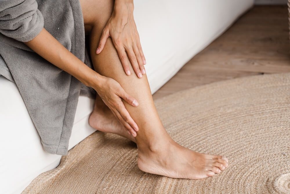 Girl touching her legs and looking at veins