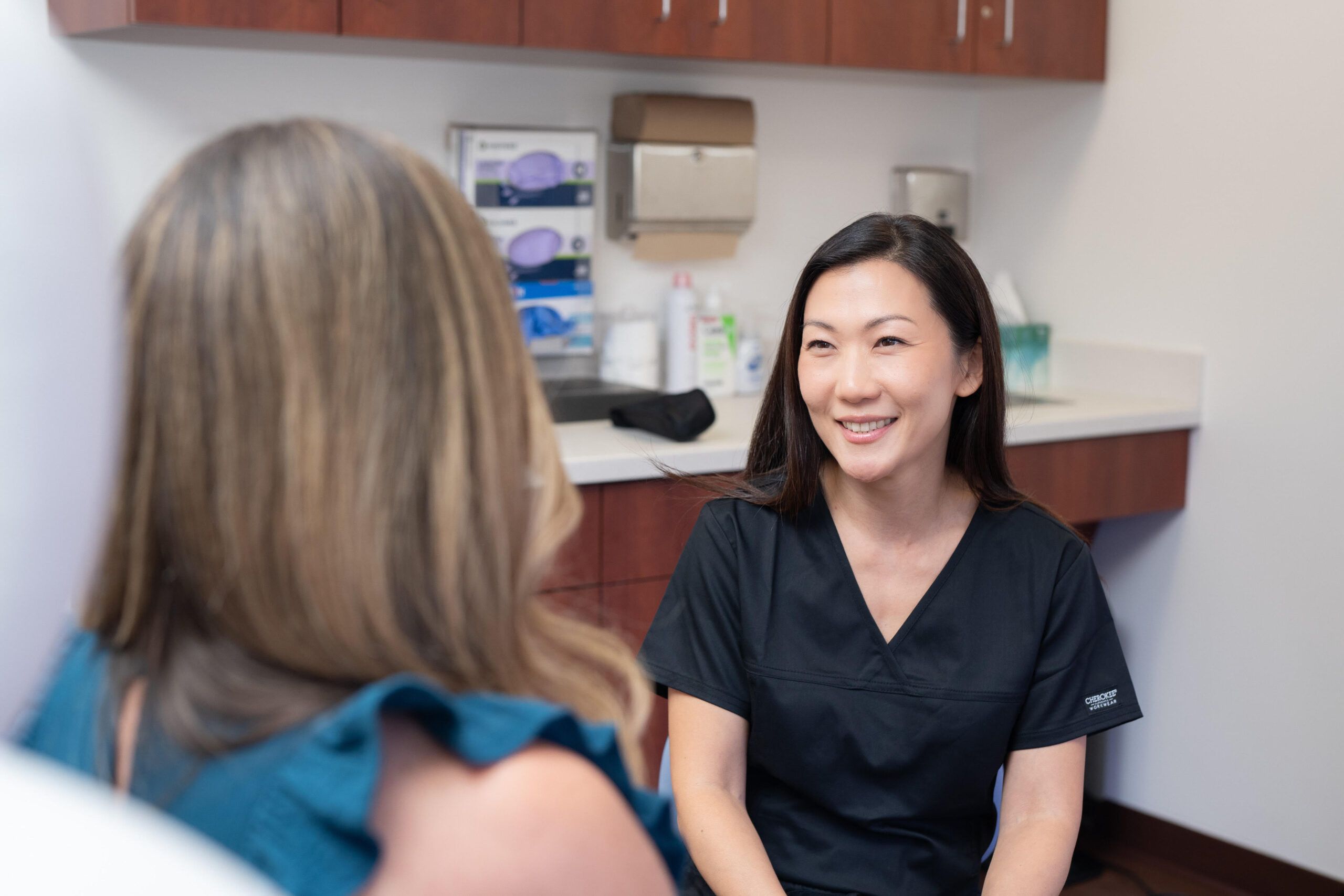 Esther Kim with patient in treatment room