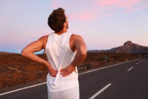 Athletic running with injury rubbing lower back