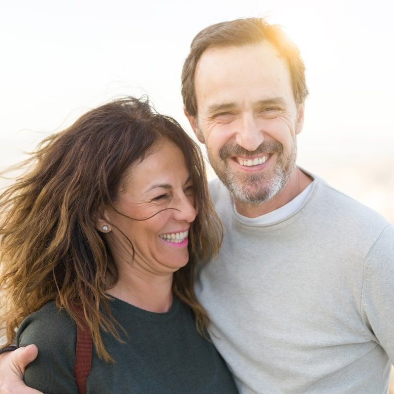 Romantic couple smiling and cuddling