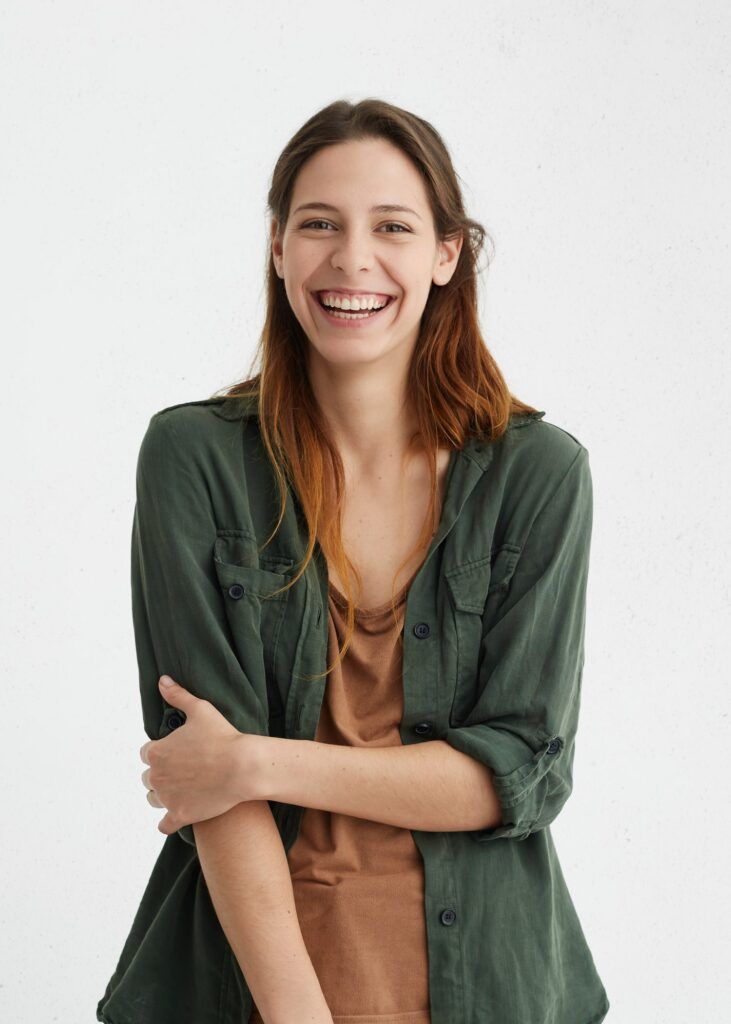 attractive sensual woman with wide smile dressed in green jacket