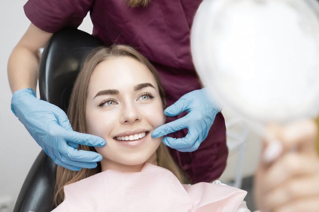 Female patient after dental treatment smiling