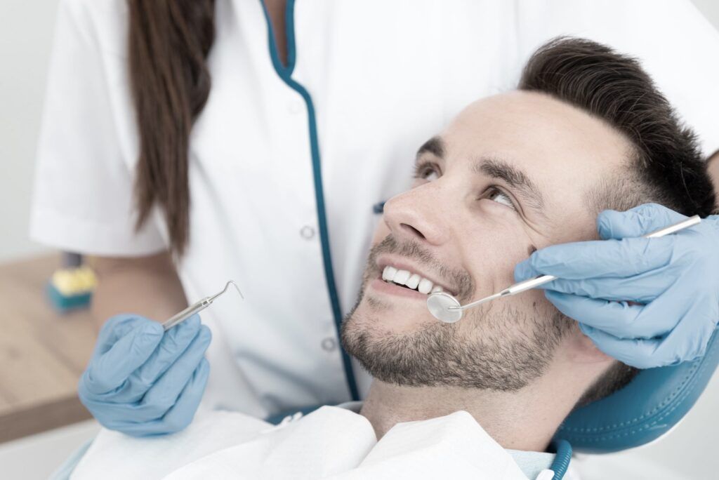 male patient smiling during dental process