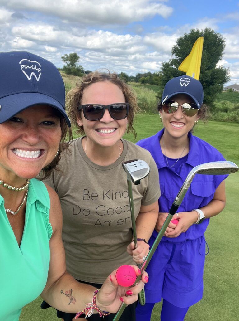 Philp Family Dentistry team members playing golf