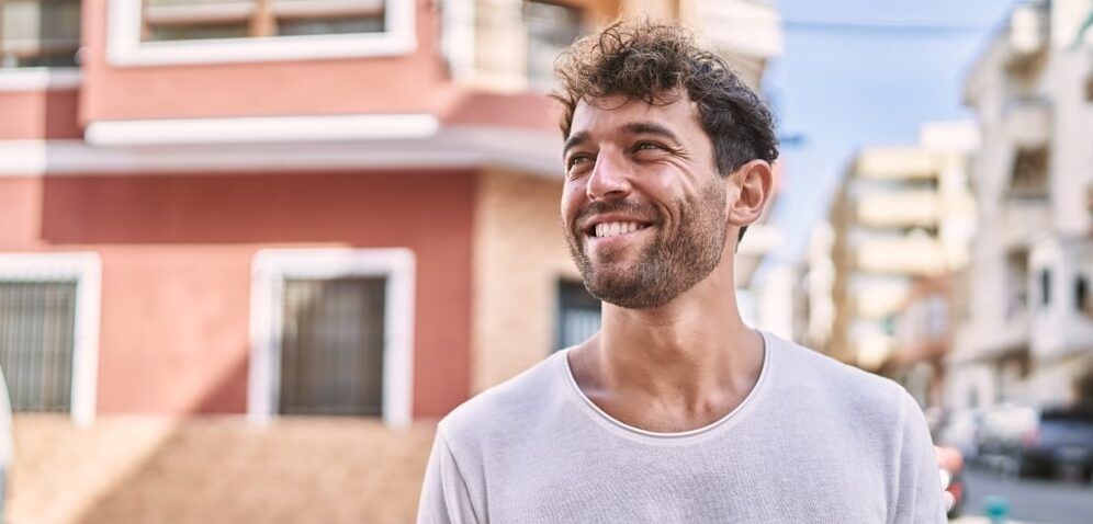 Young man smiling confident walking at street