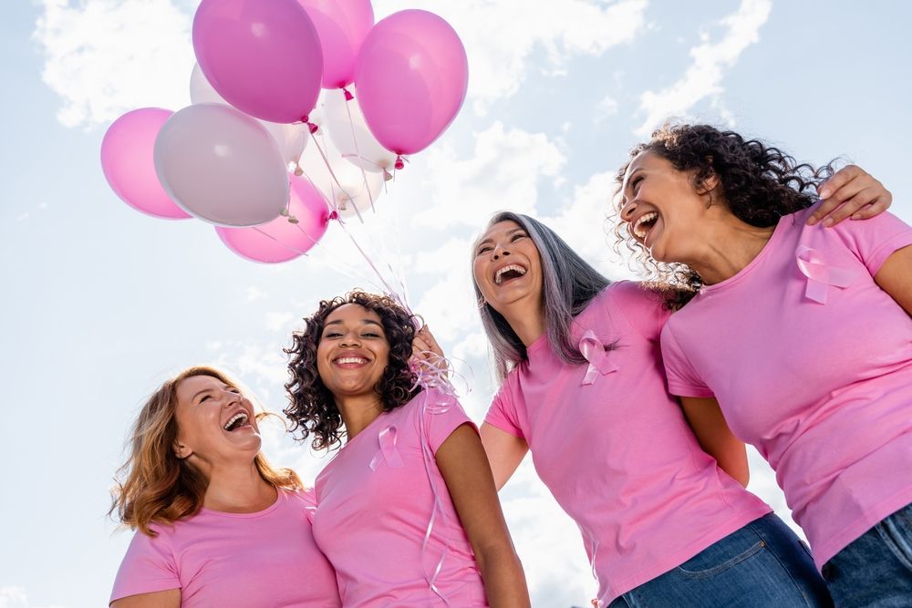 Low,Angle,View,Of,Happy,Multiethnic,Women,With,Ribbons,