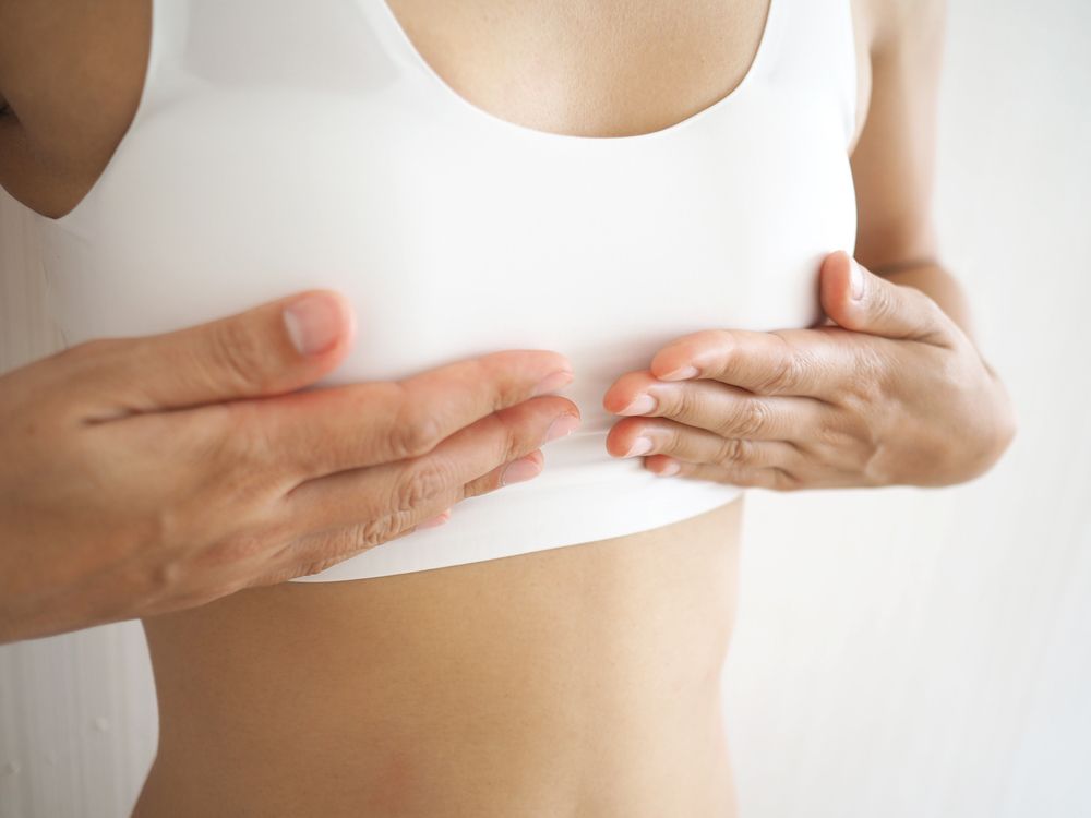 Small,Breast,Problem,A,Woman,Wearing,Exercise,Clothes,Or,White