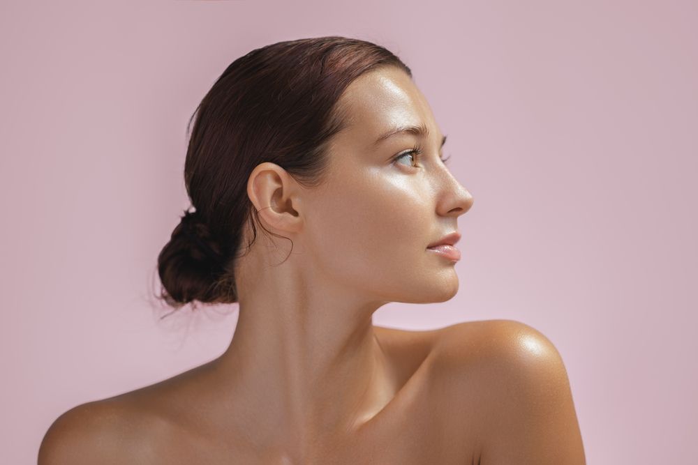 Beautiful young adult woman in profile with healthy shiny skin