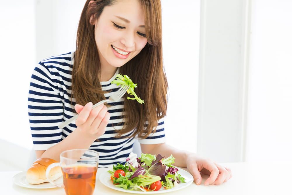 young attractive asian woman who eats