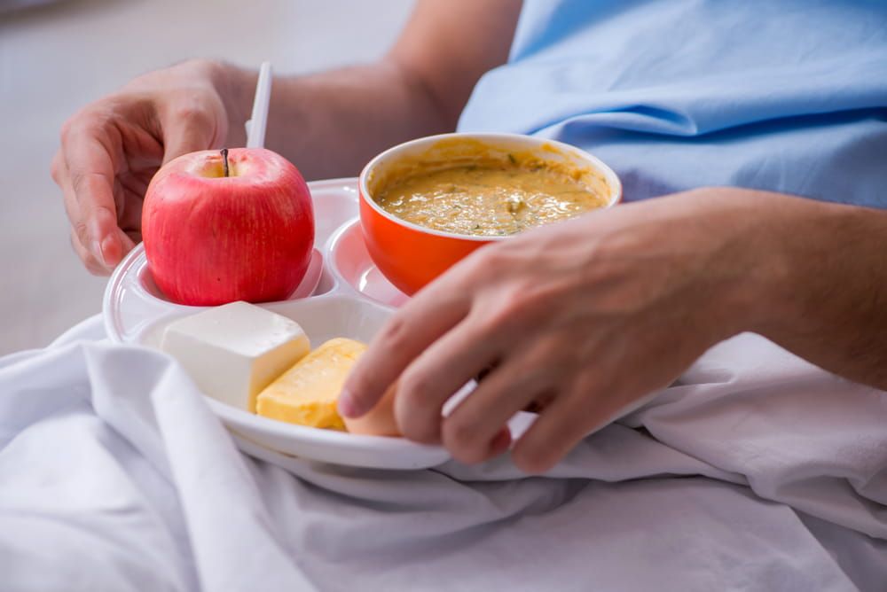 Male patient eating food in the hospital