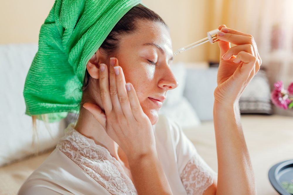 Woman applying facial hyaluronic acid serum. Skincare treatment. Product for oily skin with imperfections with acne, blackheads and large pores