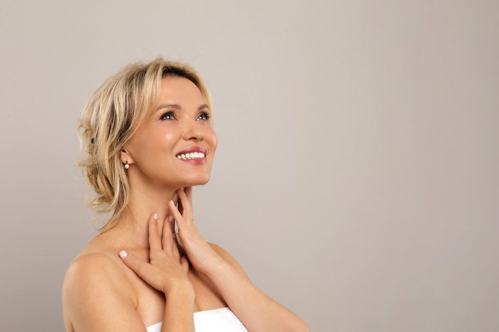 Double Chin Treatment. Beautiful Middle Aged Woman Touching Soft Smooth Skin On Neck,