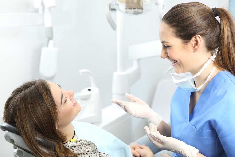 Dentist explaining procedures to a patient in a consultation
